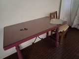 a desk with a computer on top of it in a room