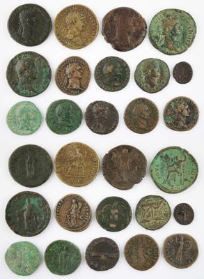 a group of ancient coins on display on a white surface