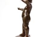 bronze statue of a young boy holding a tennis racquet on a marble base