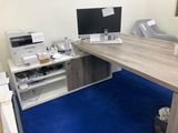 a desk with a computer and a printer on it