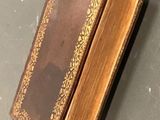 an old book that is sitting on a table