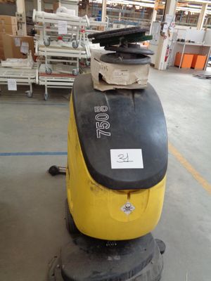 a yellow and black machine that is in a warehouse