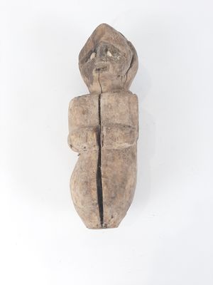 an old wooden sculpture of a man with a hat on his head