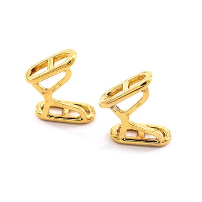 two pairs of gold plated cufflinks on a white background