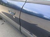 a blue car with a hole in the side of the door