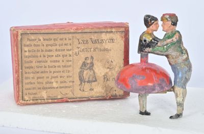 figurine représentant un homme et une femme tenant un parapluie rouge à côté d'une boîte