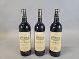 three bottles of wine sitting next to each other on a table