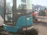 a picture of a blue and black excavator parked in a lot