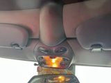 a picture of a person holding a cell phone in the back seat of a car