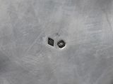 close up of a metal plate with a hole in the middle