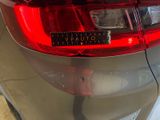 a close up of a car ' s tail light with a sticker on it