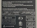 the back side of a laptop with a black and white label on it