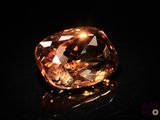 an orange diamond is shown on a black surface