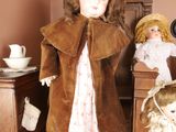 two dolls that are standing next to each other in a room