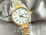 a watch that is laying on a white cloth