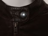 a close up of a leather jacket with a button on it
