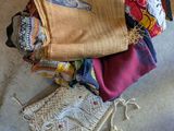 a pile of cloths sitting on the floor next to a chair