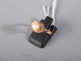 a small piece of wire that has a pearl on it