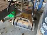 a machine that is sitting on the floor next to a pile of wood