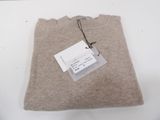 a brown sweater with a tag on it sitting on a table