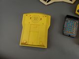 a yellow phone and a yellow cell phone on a table