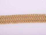 a close up of a gold chain bracelet on a white background