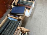 several boxes of books are lined up on the floor in a room