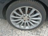 a close up of a car ' s tire on a gravel road