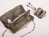 an old purse with a chain around it sitting on a white surface