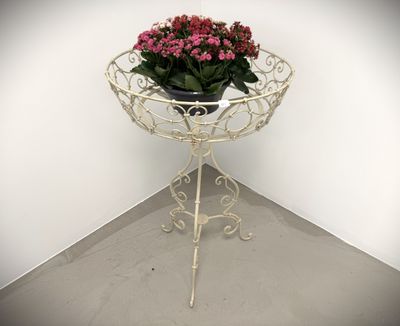 a potted plant sitting on top of a metal stand