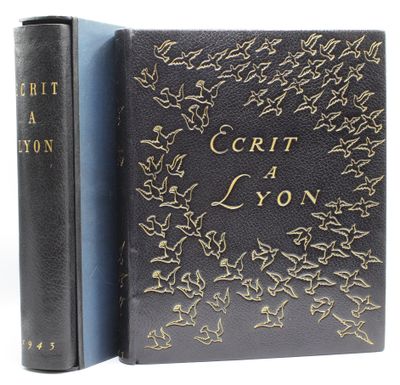 a black book with gold lettering on it sitting next to a black book