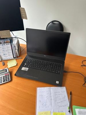 a laptop computer sitting on top of a wooden desk