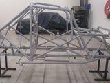 an image of a car frame being built in a garage