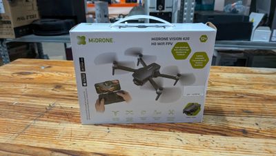 the box is open on a wooden table with a remote control