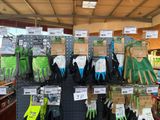 many different types of gardening gloves on display in a store