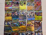 a pile of pokemon cards sitting on top of a white table