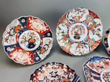 four plates with different designs on them sitting on a table
