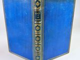 an old blue book with gold trim and a blue cover