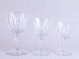 three wine glasses sitting next to each other on a table