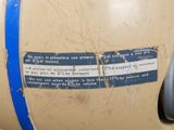 a sign on the side of a tank that has a blue stripe on it