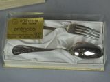 two forks and a spoon in a box on a table