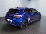 the rear end of a blue car in a showroom
