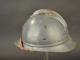 a helmet that is on a stand on a gray background