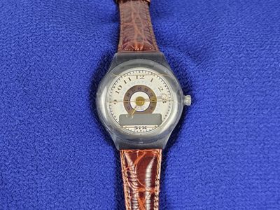 a watch that is sitting on a blue cloth
