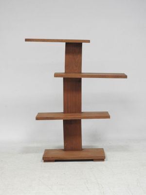 a close up of a wooden shelf with three shelves on it