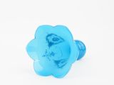 a close up of a blue flower shaped object on a white background