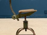 a metal chair that has a wooden seat on top of it