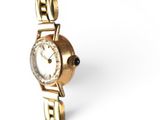 a close up of a watch on a white surface