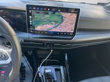 a car dashboard with a gps device and a cell phone in it