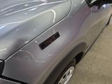a close up of a car with a sticker on it ' s hood